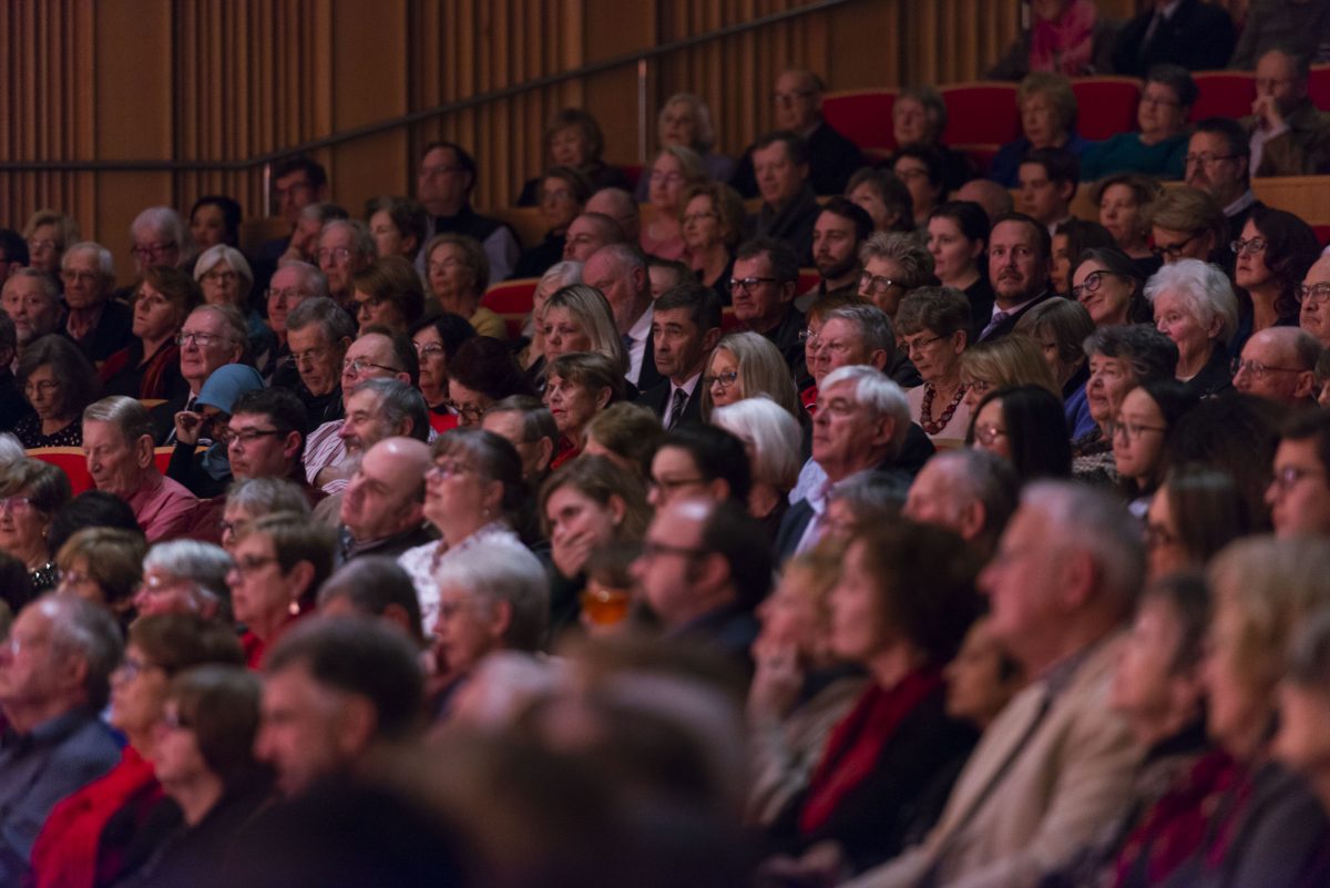 Photo of people sitting at an orchestra
