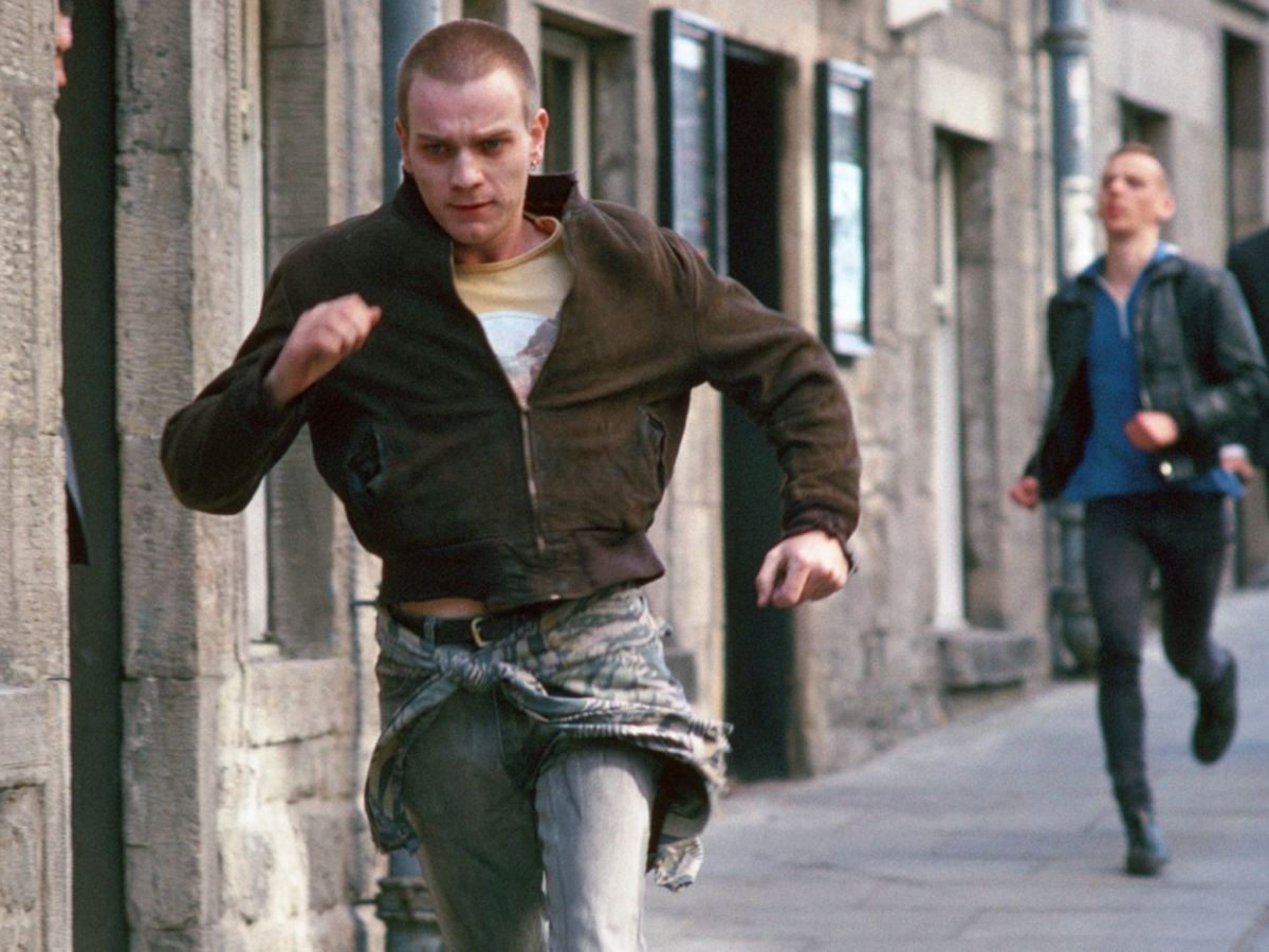 Still from Trainspotting showing two young men running down a street