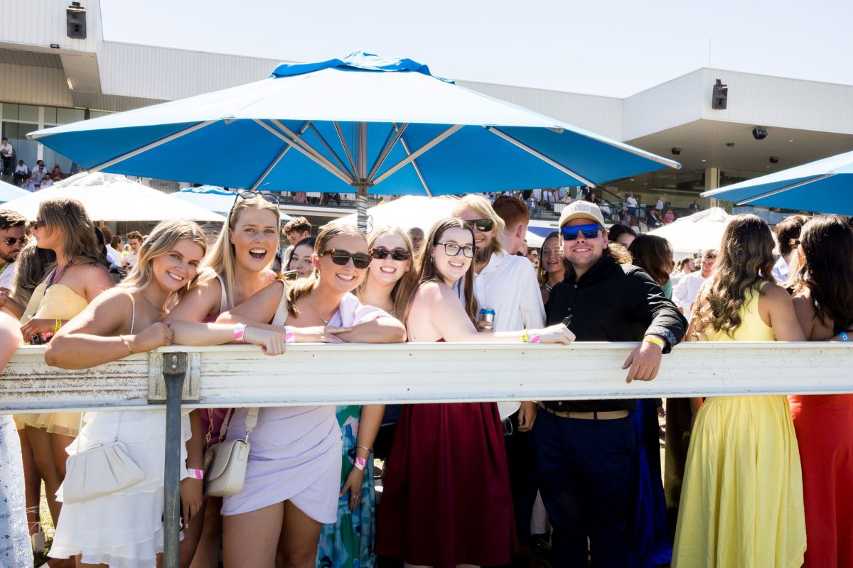 racegoers standing trackside at Thoroughbred Park