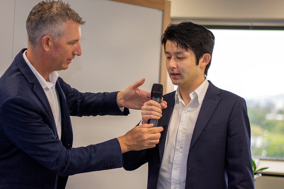 Cam Sullings directing a person speaking into a microphone