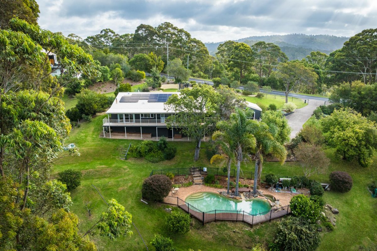 drone shot of home, gardens and pool