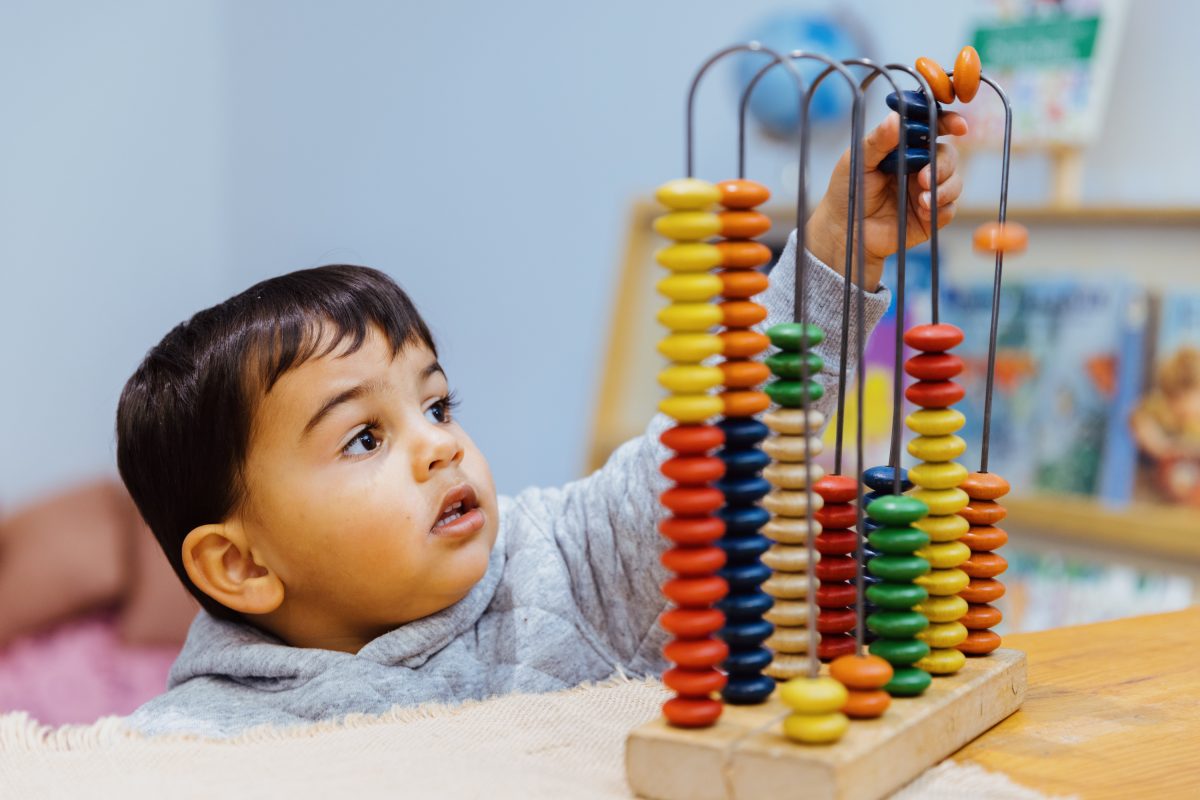 Kid playing with an abacus toy