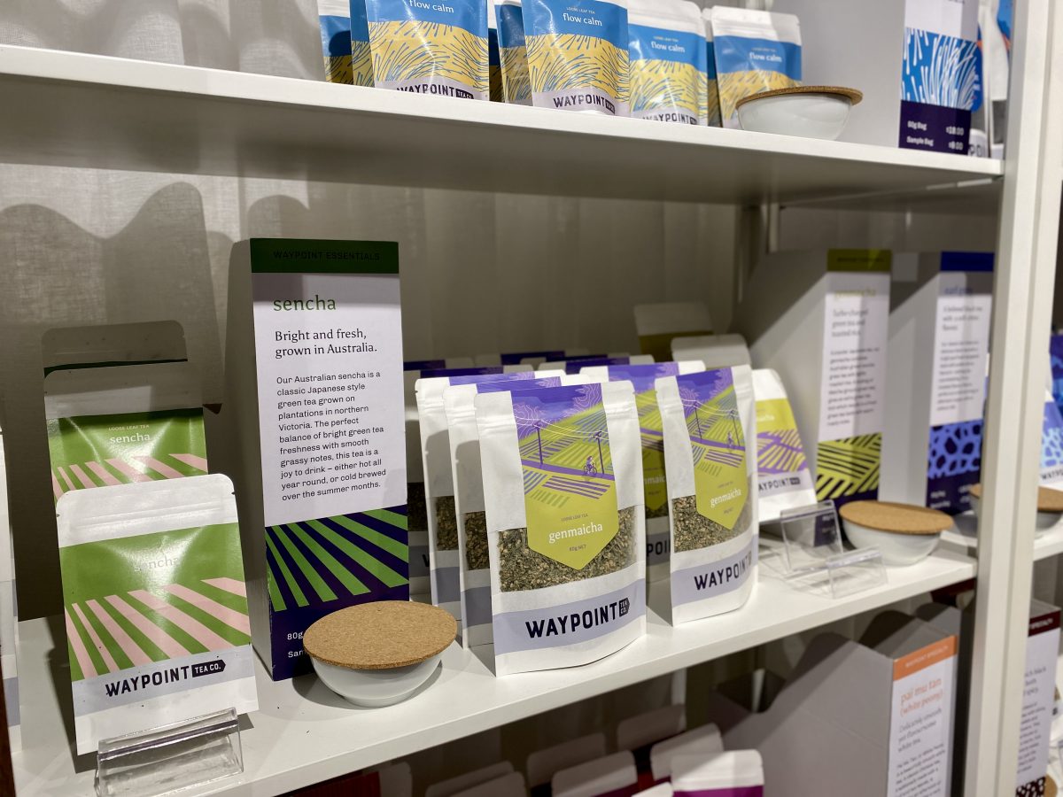 Tea packets on a shelf, including some text information about Sencha tea,