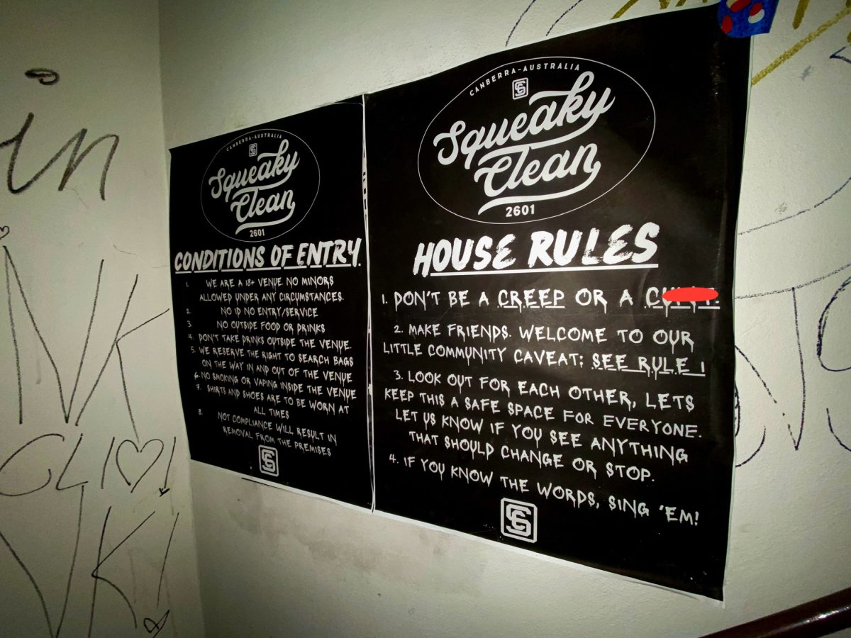 A black sign with white writing stating Squeaky Clean's House Rules.