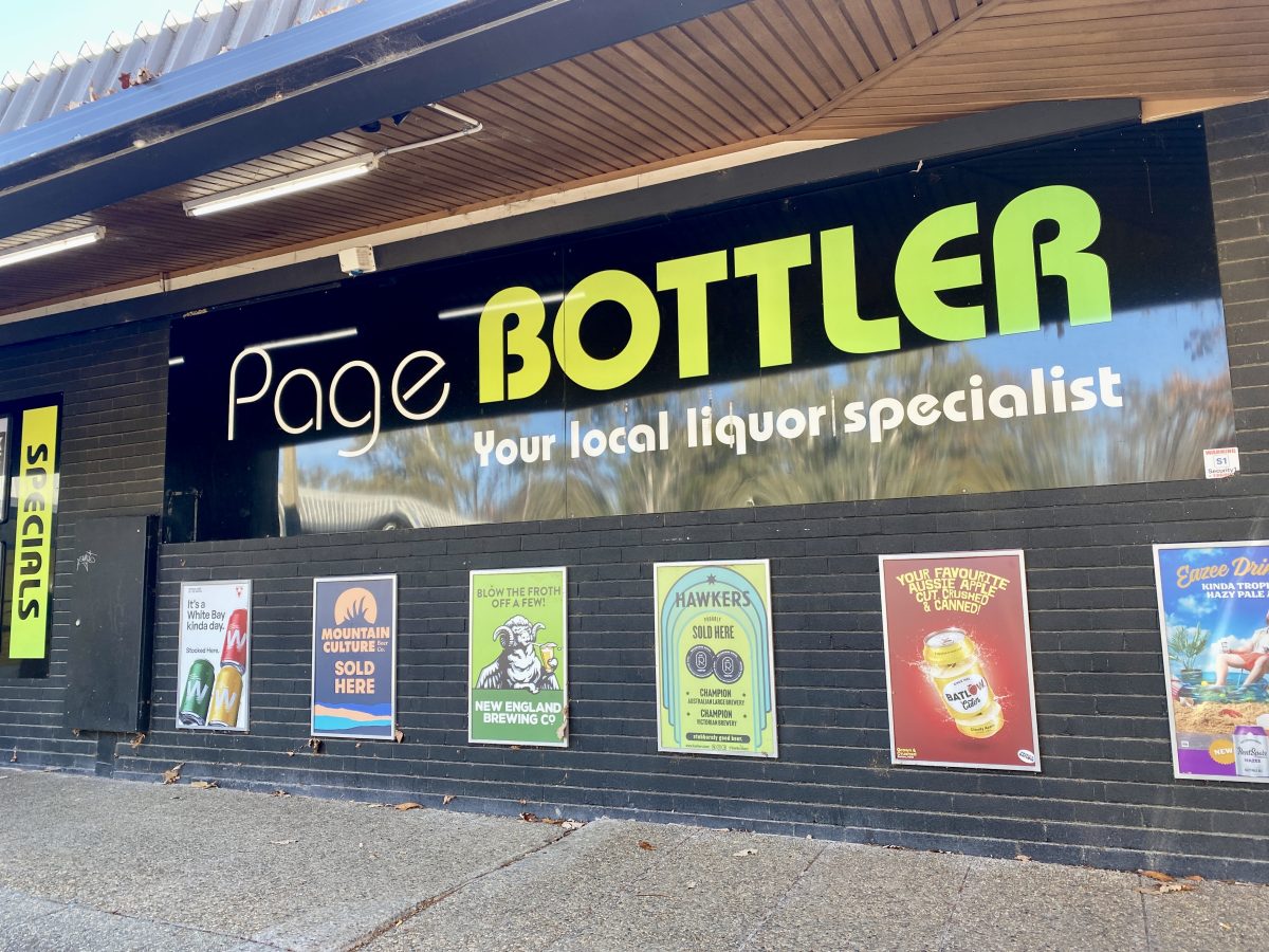 Exterior of shop with large sign reading "The Page Bottler"