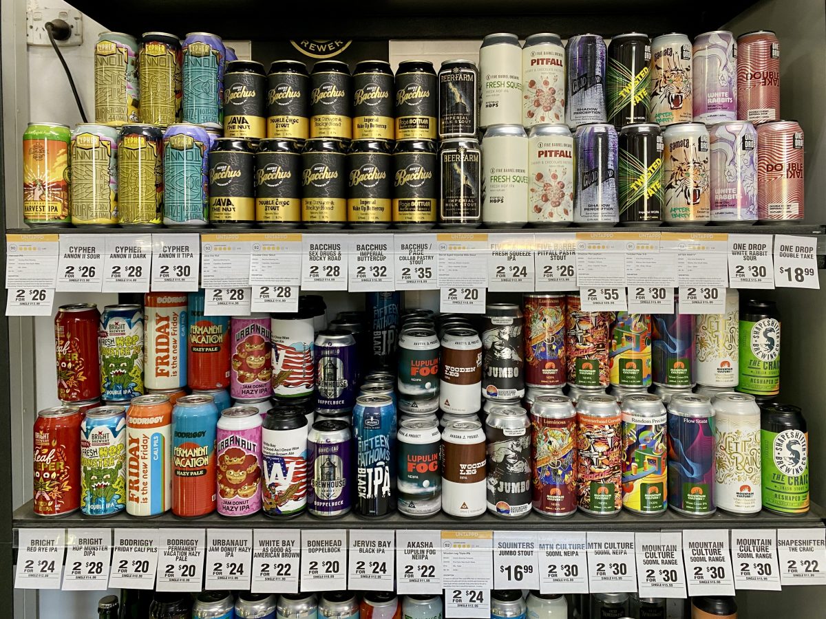 a shelf full of colourful beer cans.