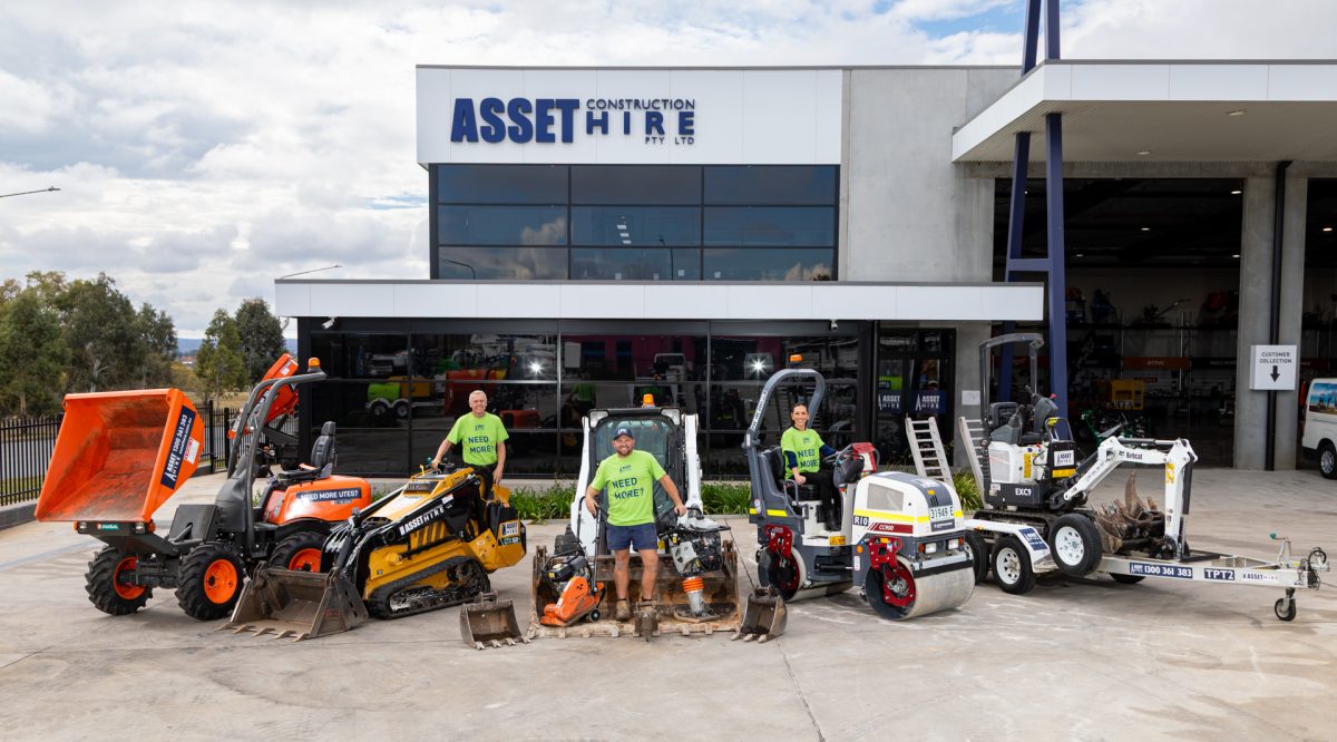 Three Asset Hire staff members with machines outside the business