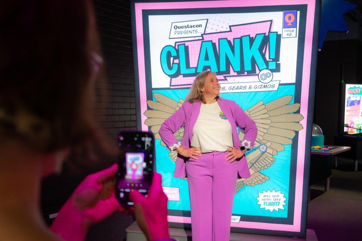Woman in front of a sign, posing for a photo