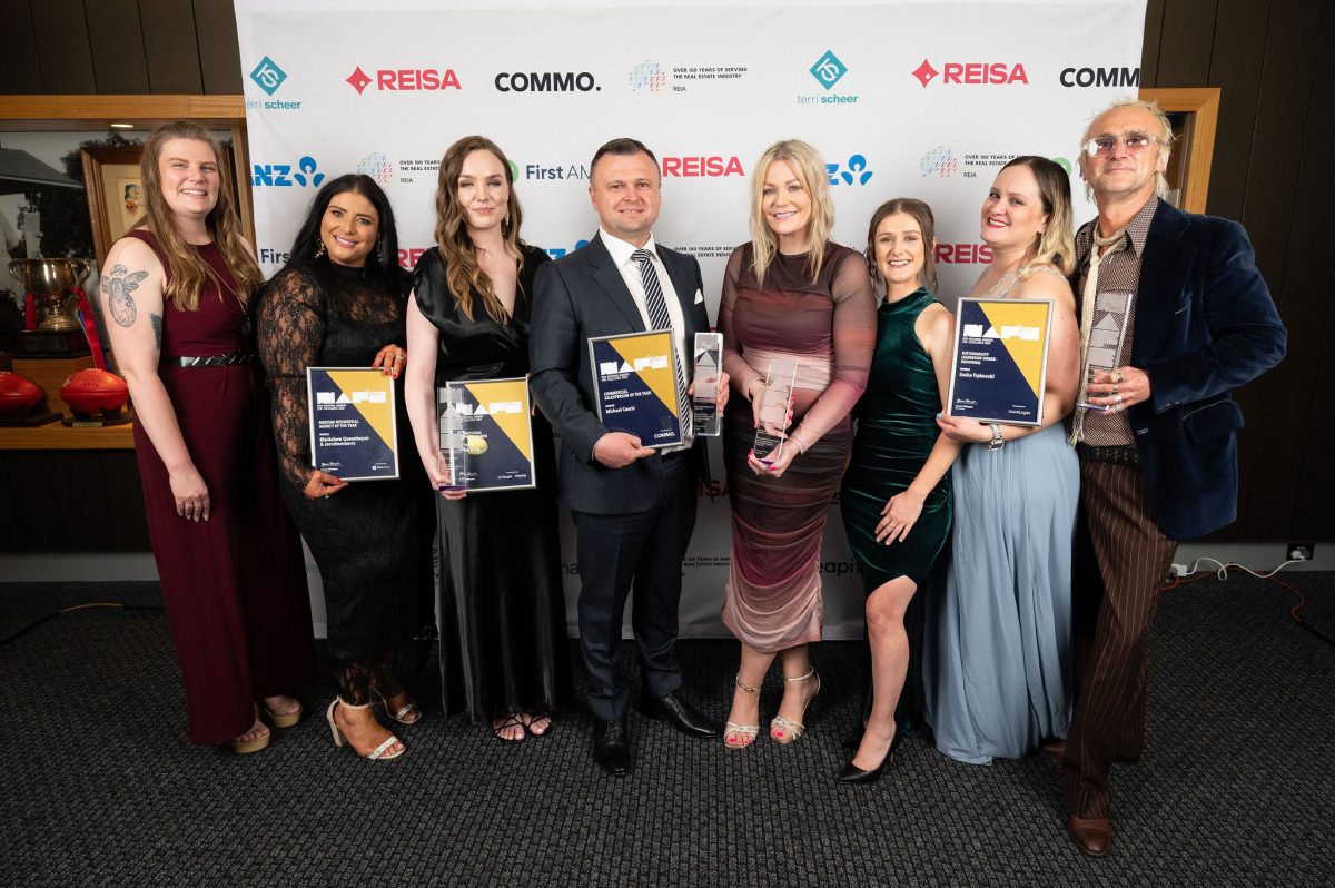 a group of people holding their awards