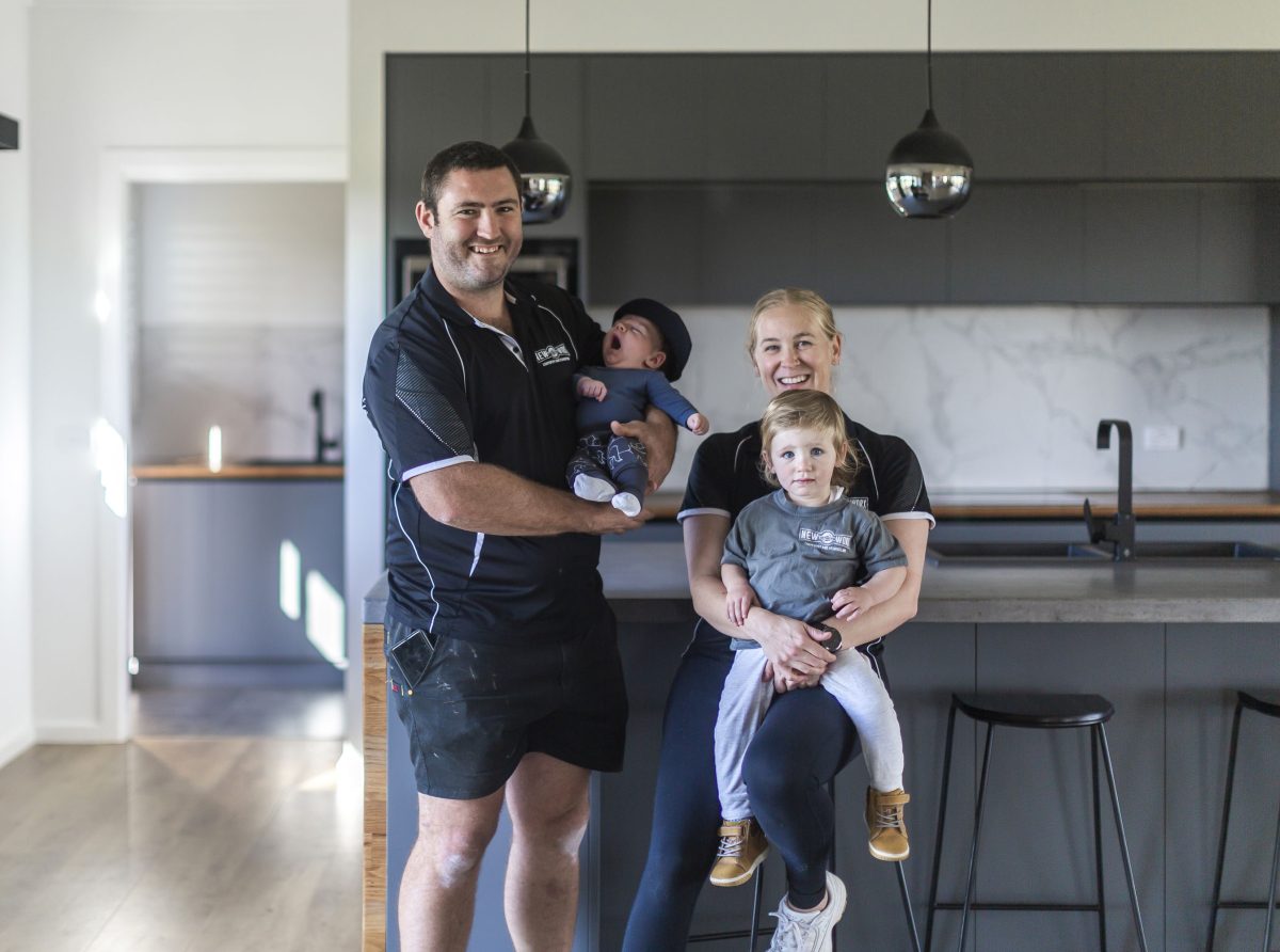 Family photo infront of their project