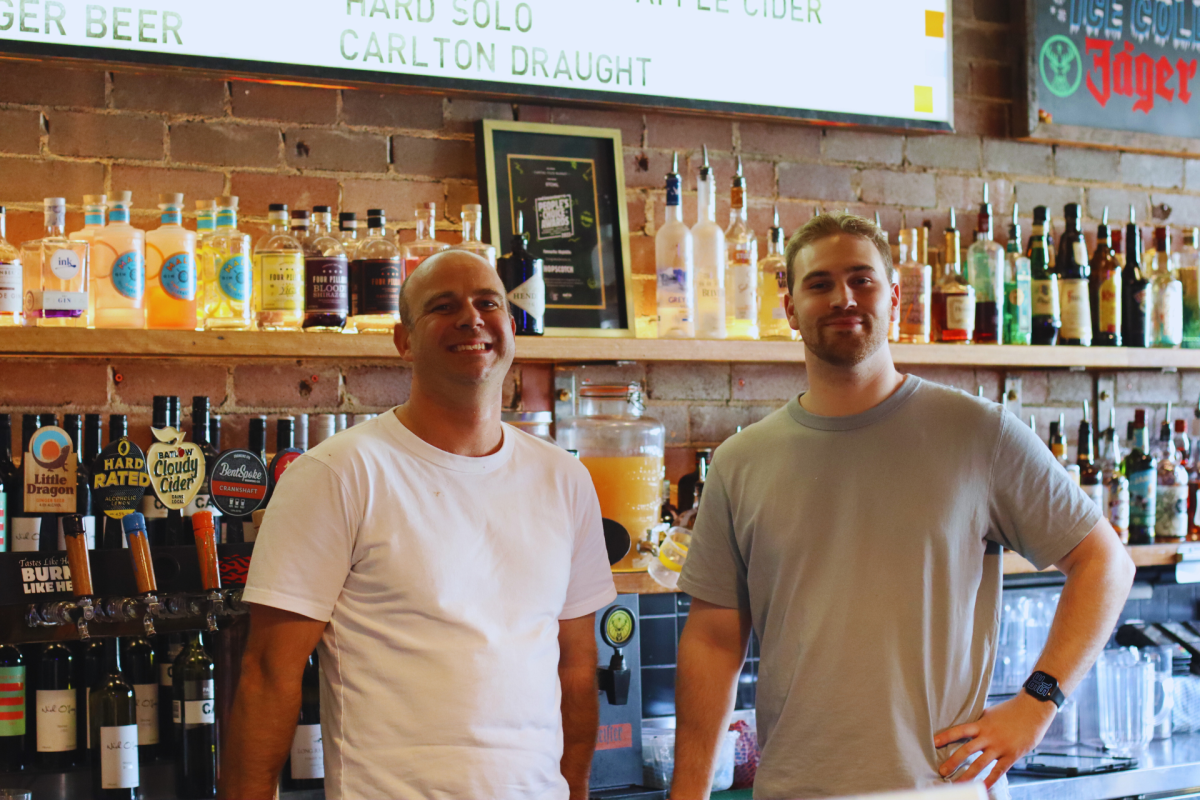 Hopscotch business partners Nick Parkinson and Fraser Maher in front of a bar.
