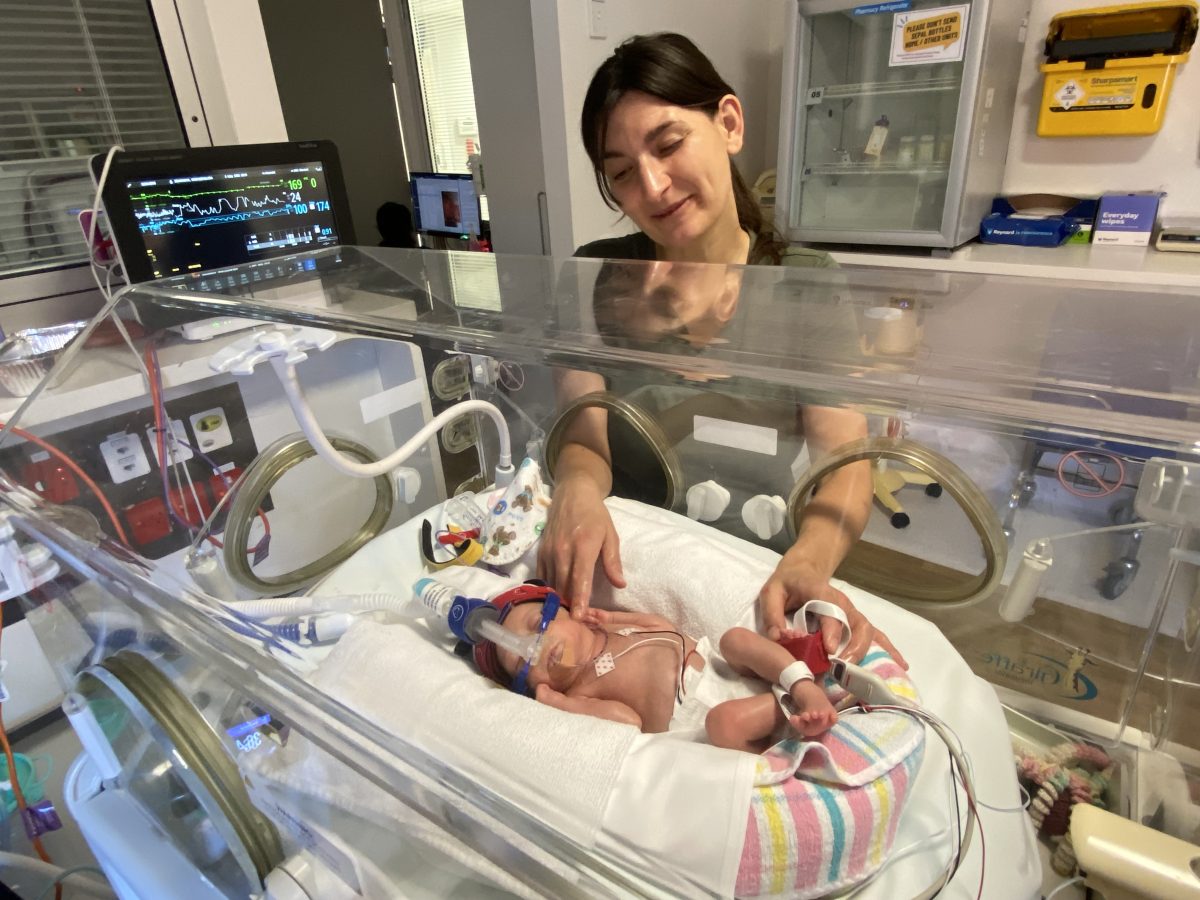 mother with her premature baby in a humidicrib