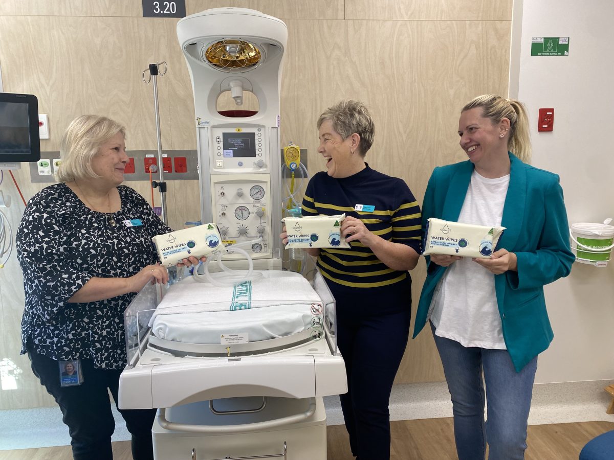 smiling women holding CleanLife wet wipes