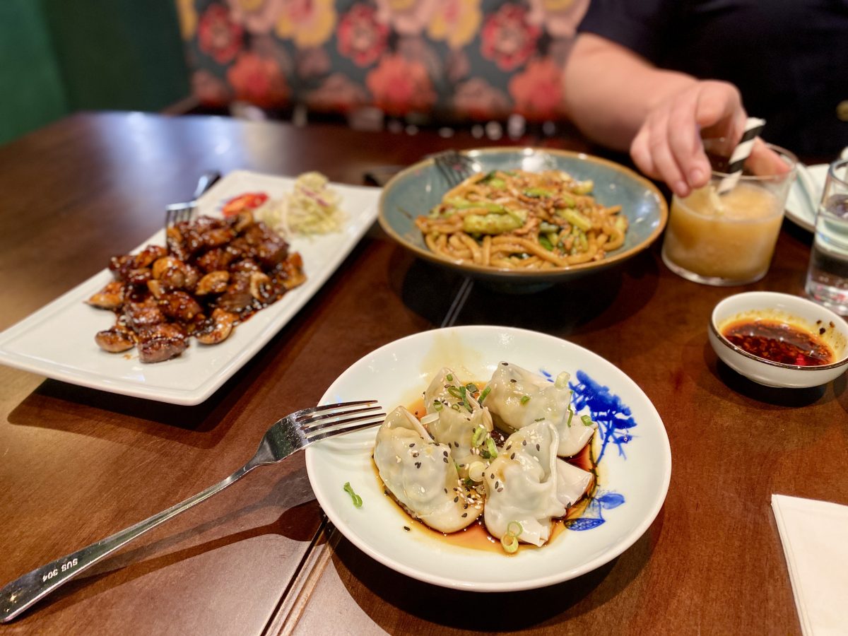 A dish of dumplings, another of beet and noodles in the background.