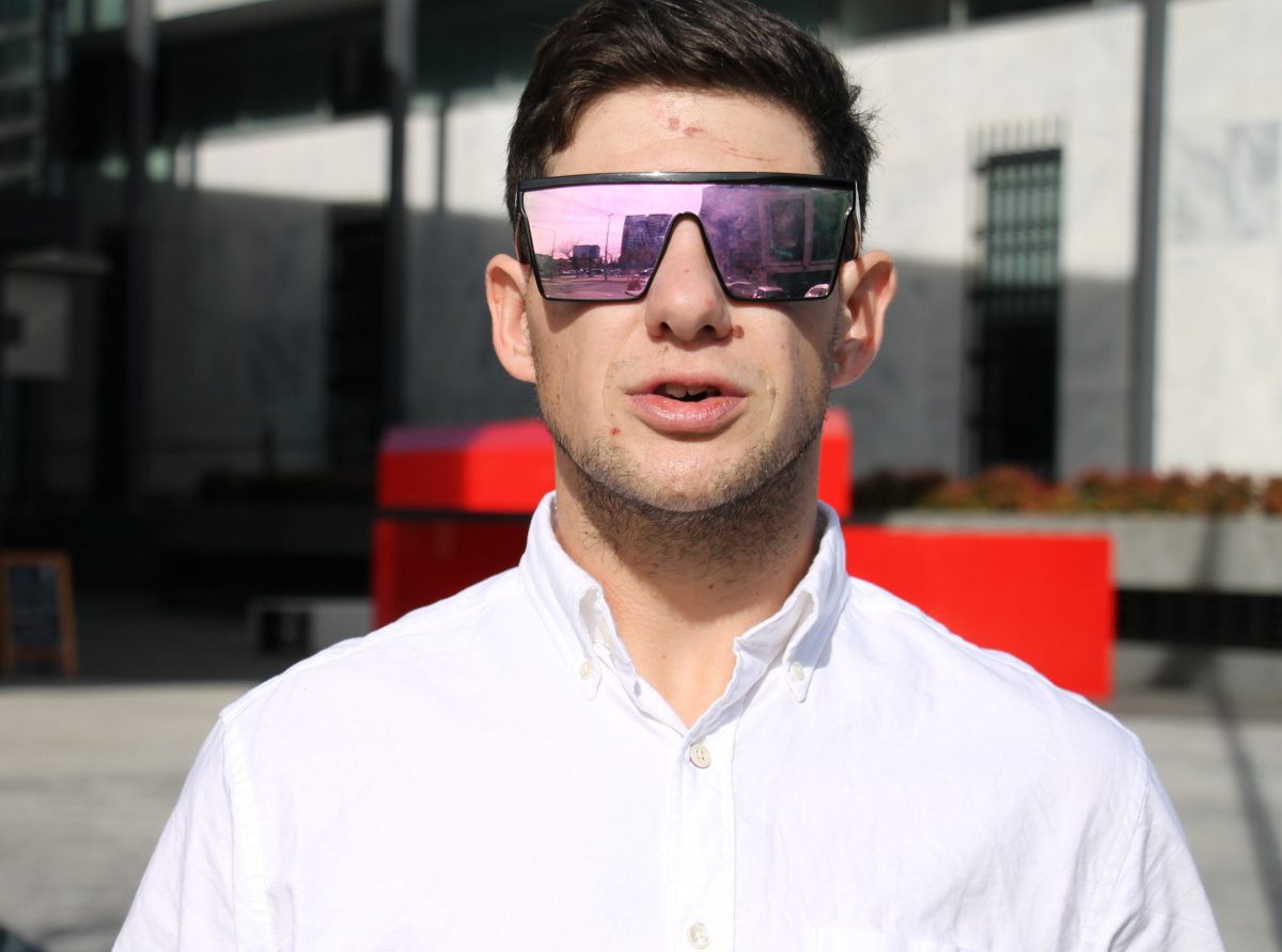 man wearing a white shirt and sunglasses