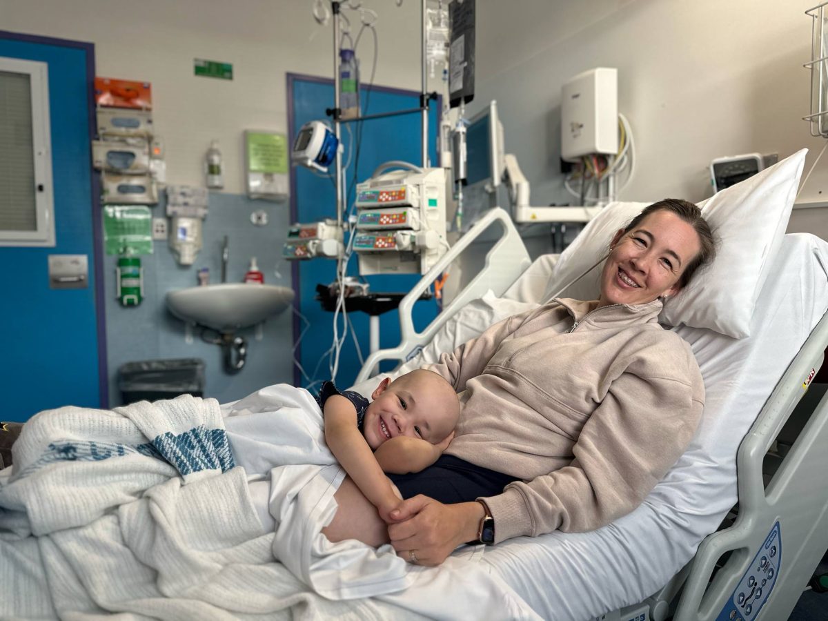 Harry and Rebecca Buckland lying in a hospital bed