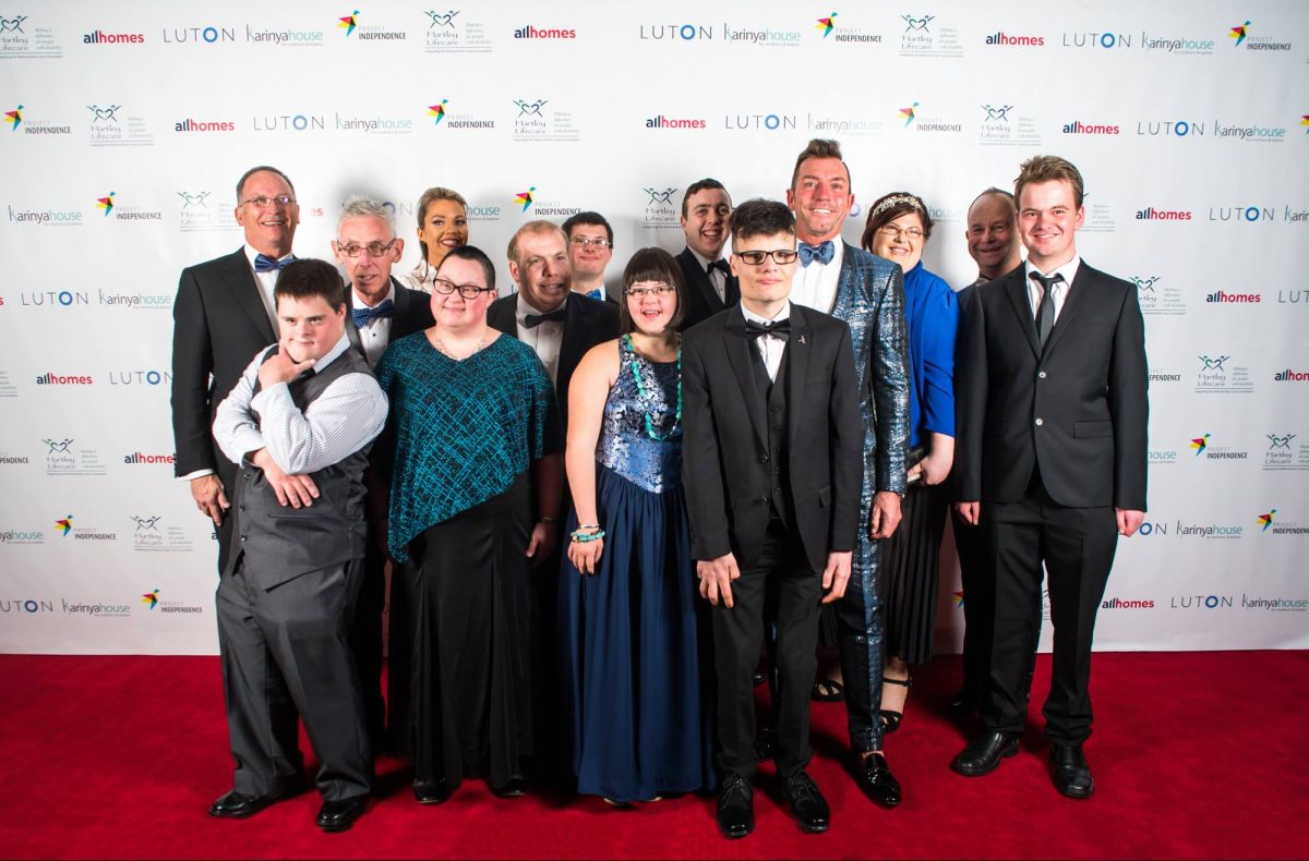 group of gala guests and PI residents posing for photo