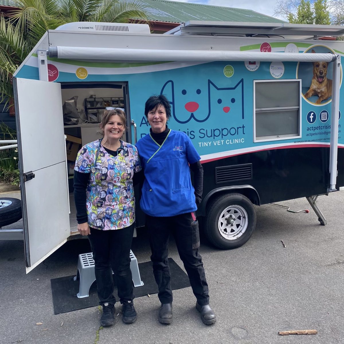 women in front of a van