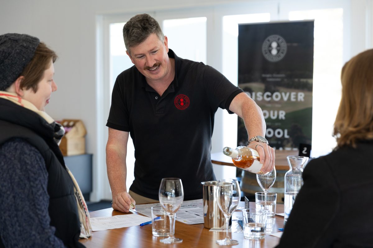 Tim at Eden Road pours wine during a cellar door wine tasting experience