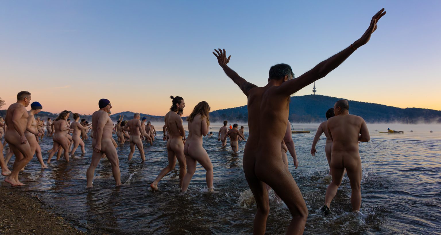 Frosty, fearless and fully nude: Winter solstice swimmers prove courage comes in many forms