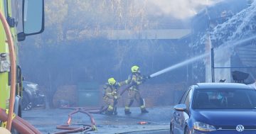 'There's like fire all on the floor of the garage here': fire brings down roof of Fyshwick business
