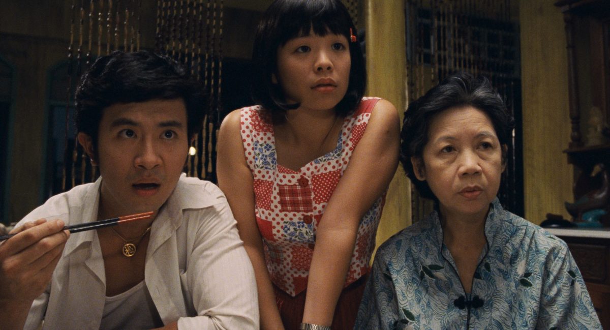 still from movie showing family staring across table