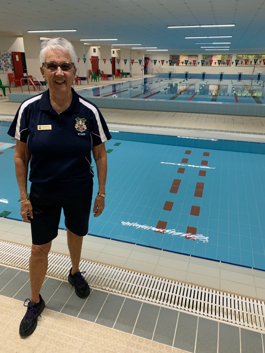 woman standing by a pool