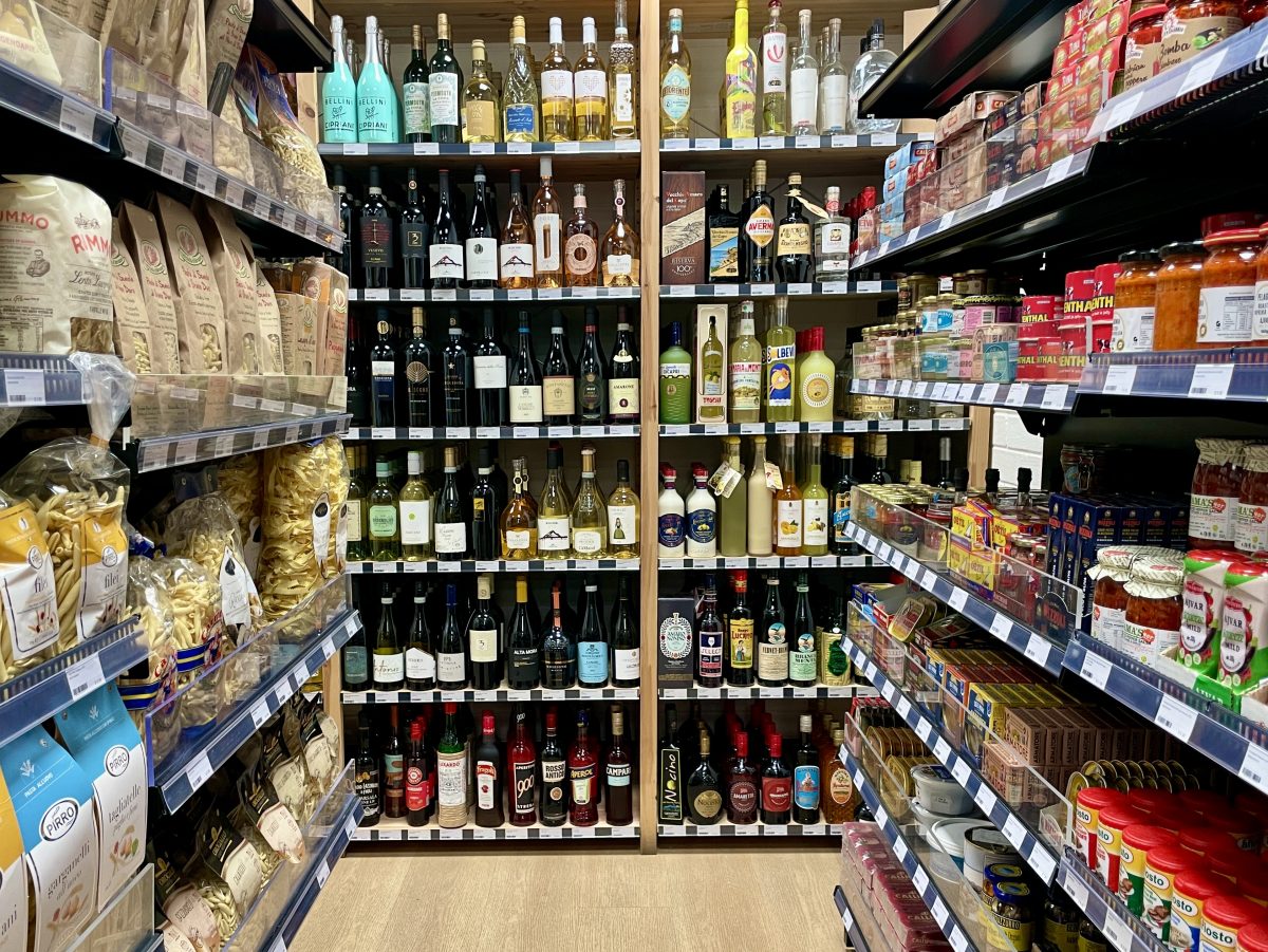 A shot between the aisles with past on one side, jars on the other and wines straight ahead.