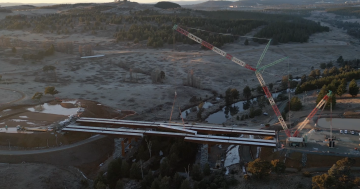 WATCH: Final steel girder in place for Molonglo River Bridge, one month behind schedule