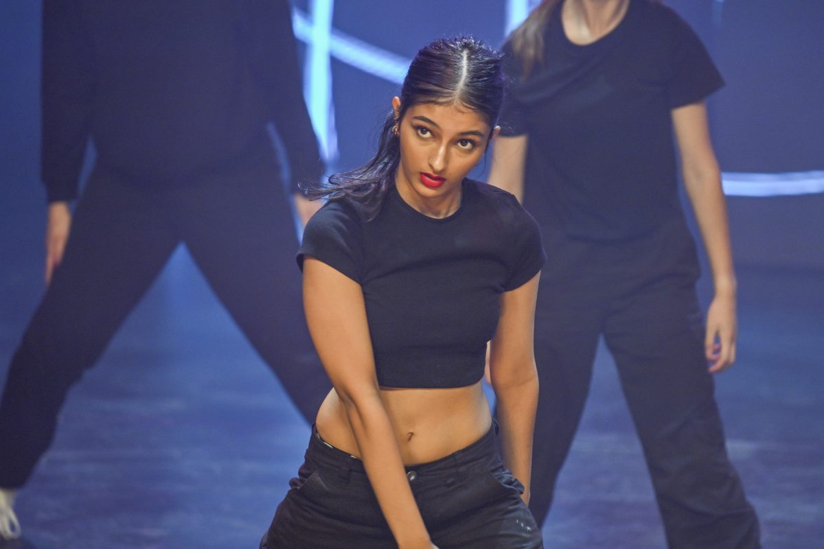 Woman in black dancing on stage