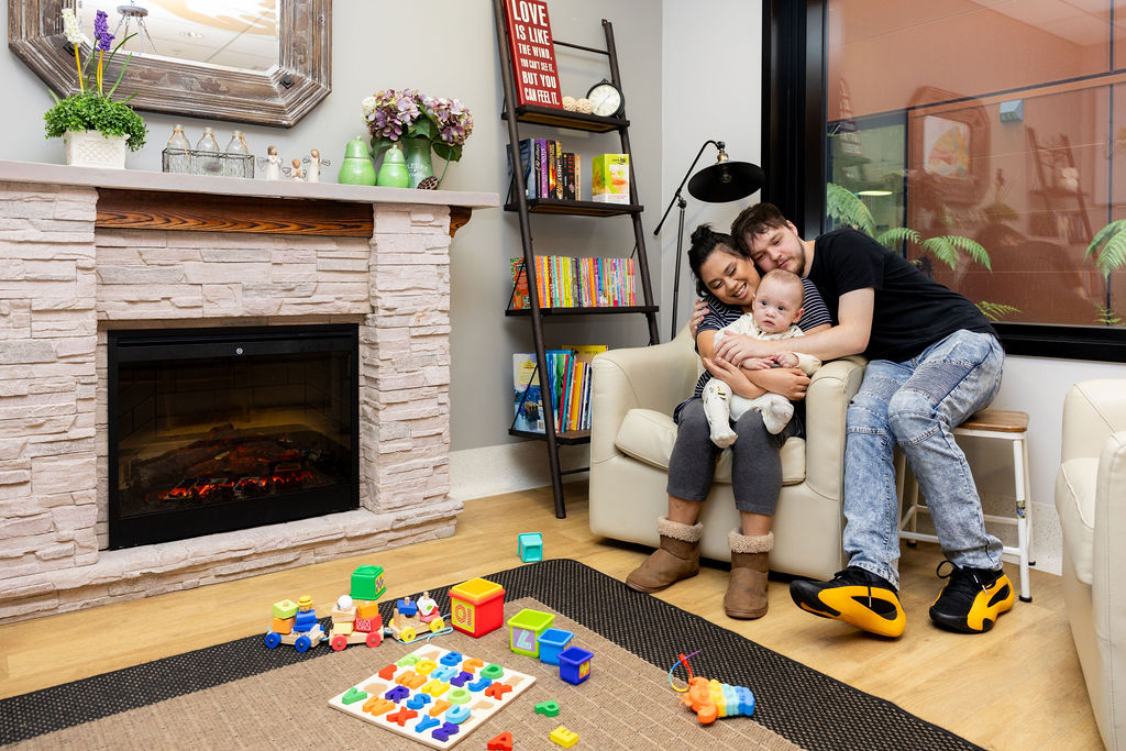 parents smiling with baby in RMHC Family Room
