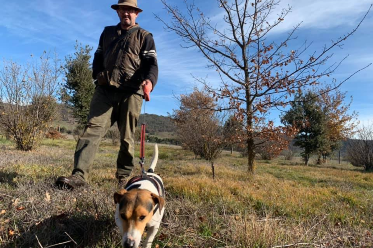 A man with a dog on a leash.