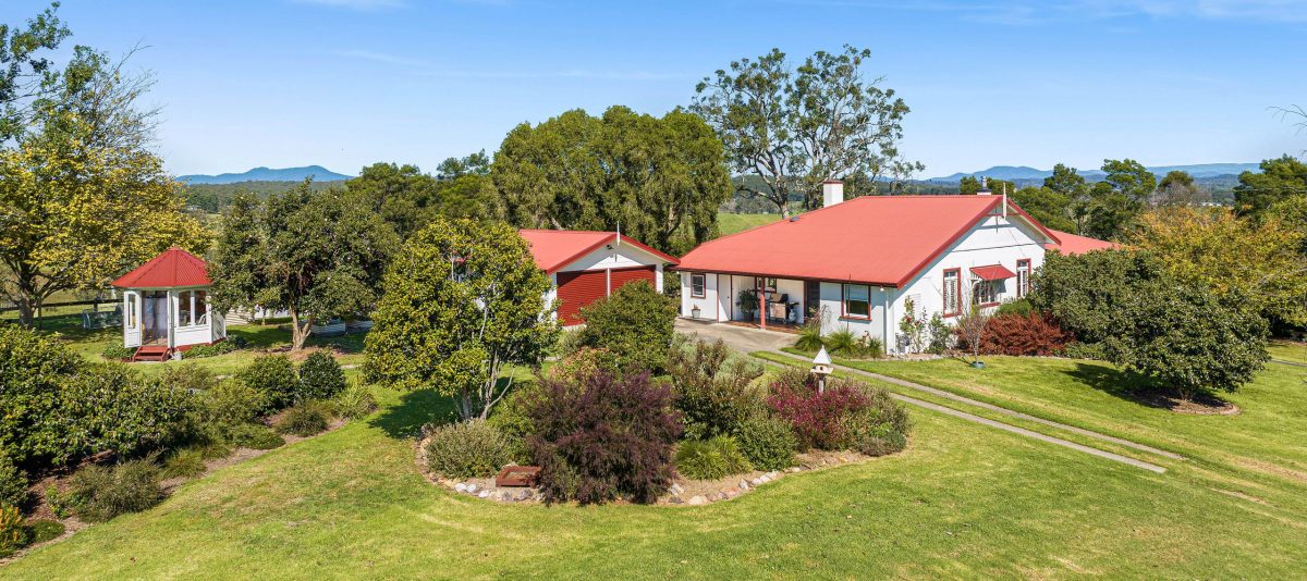 view over gardens showing house, creative studio and sheds