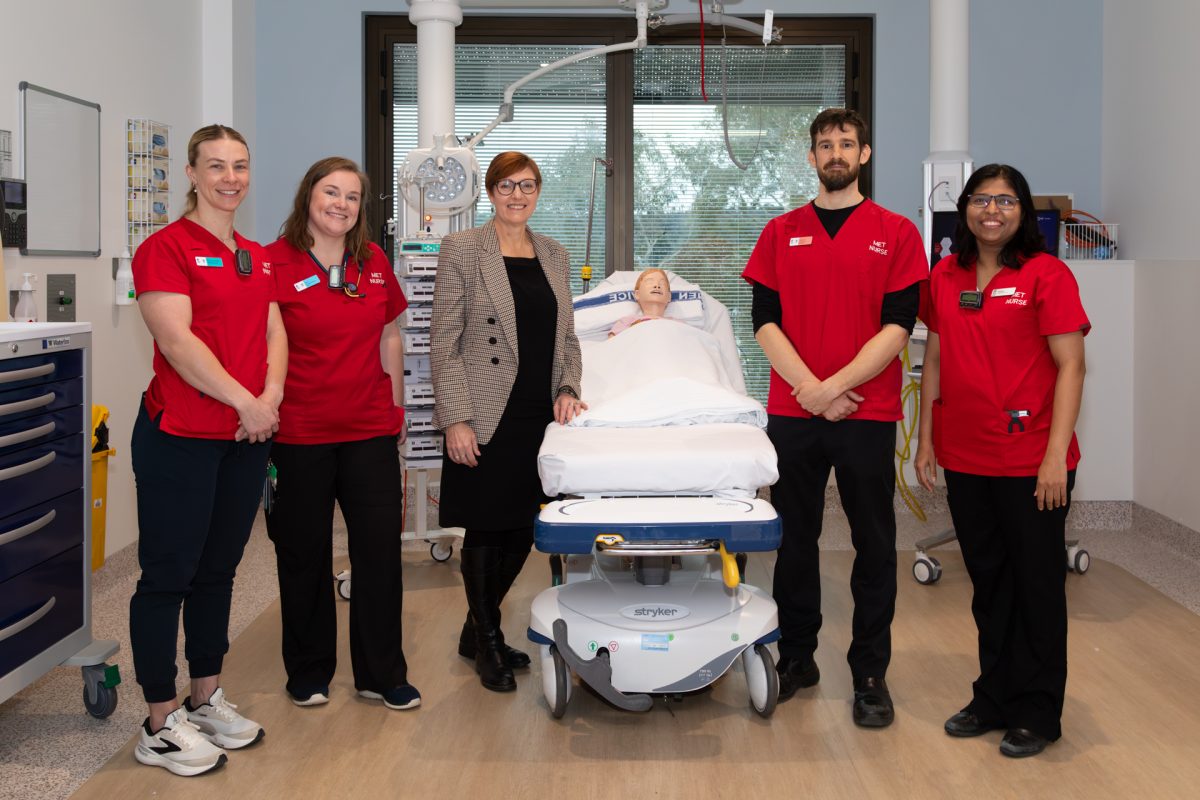 Group photo of 5 people in a hospital room