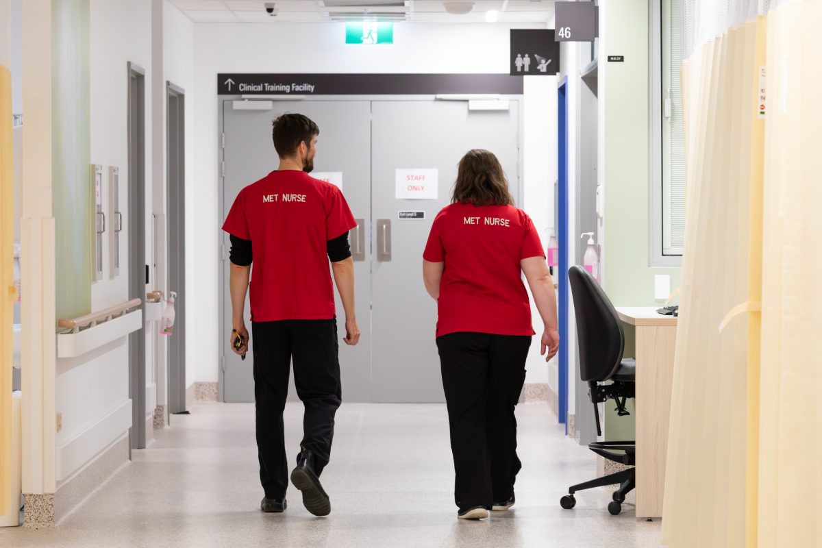 Two nurses walking down a hospital corridor