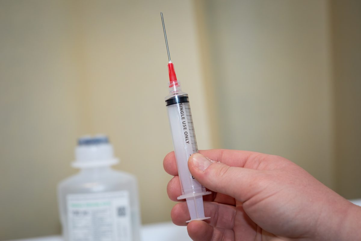 Nurse holding a needle