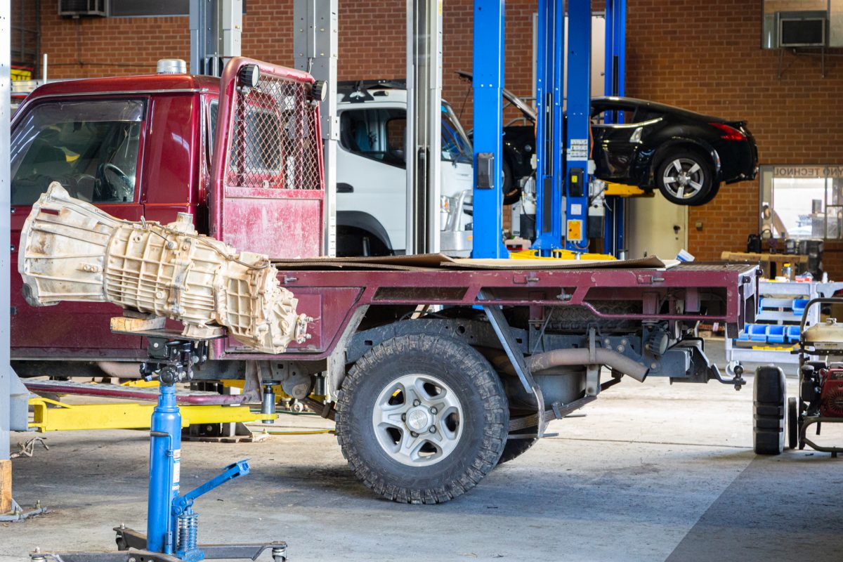 Mechanical workshop with various vehicles on hoists