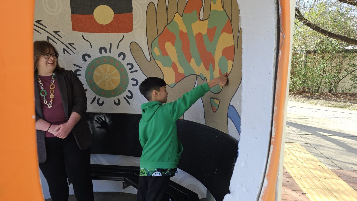Suzanne Orr is shown new artwork by Year 6 Noah Young