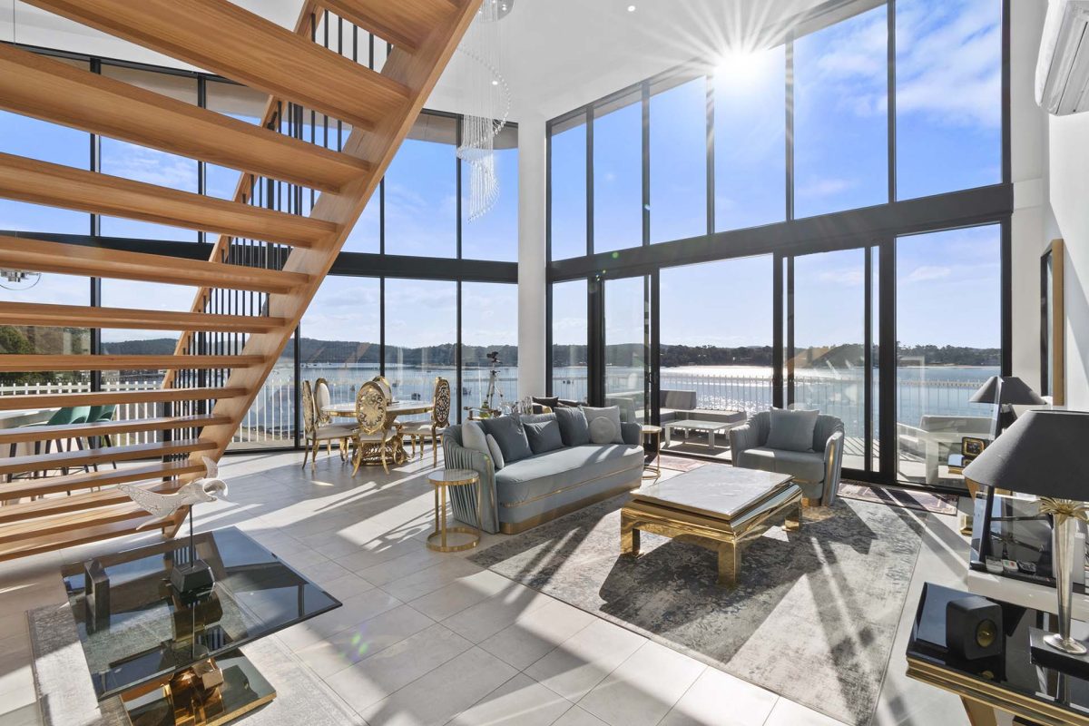 penthouse lounge with floor to ceiling windows overlooking the bay