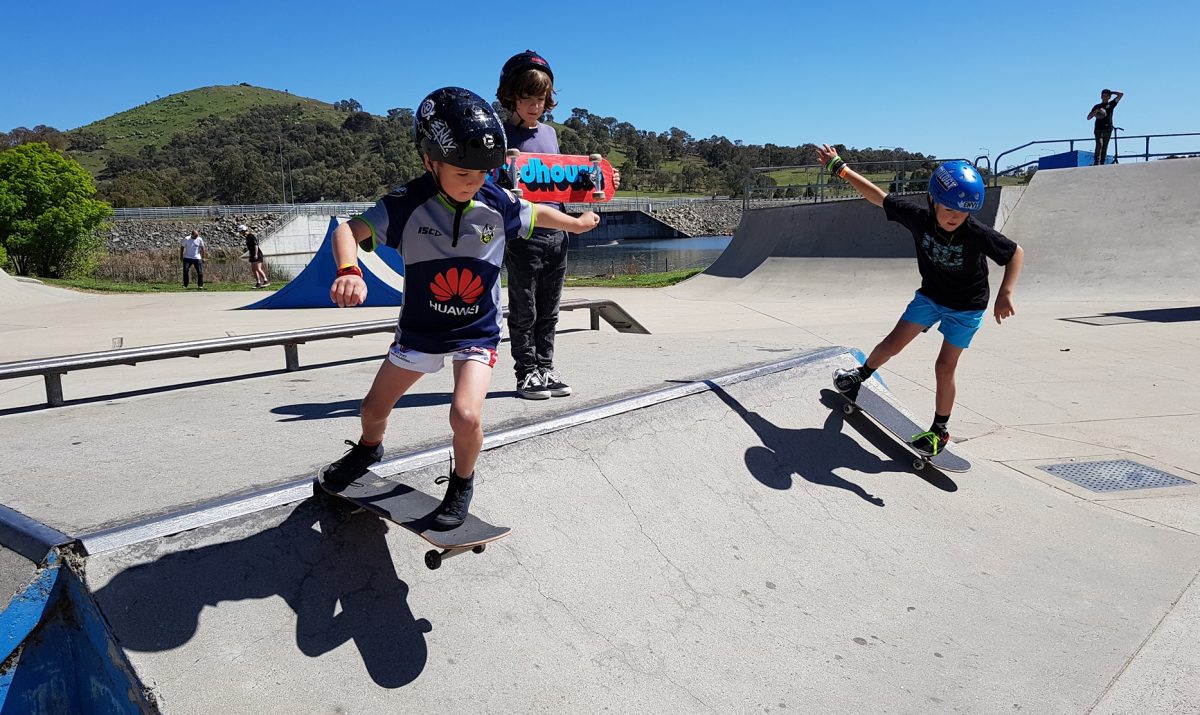 Children skateboarding at a skatepark