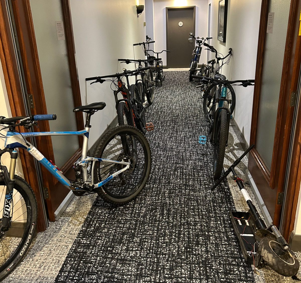 Hallway full of bikes, e-bikes and e-scooters.