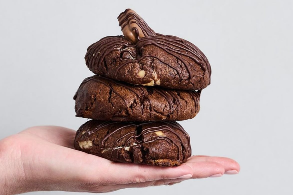 A stack of cookies in a hand.