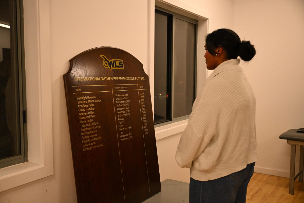 Iris Verebalavu looking at the Uni North Owls Honour Board. Photo: Supplied.