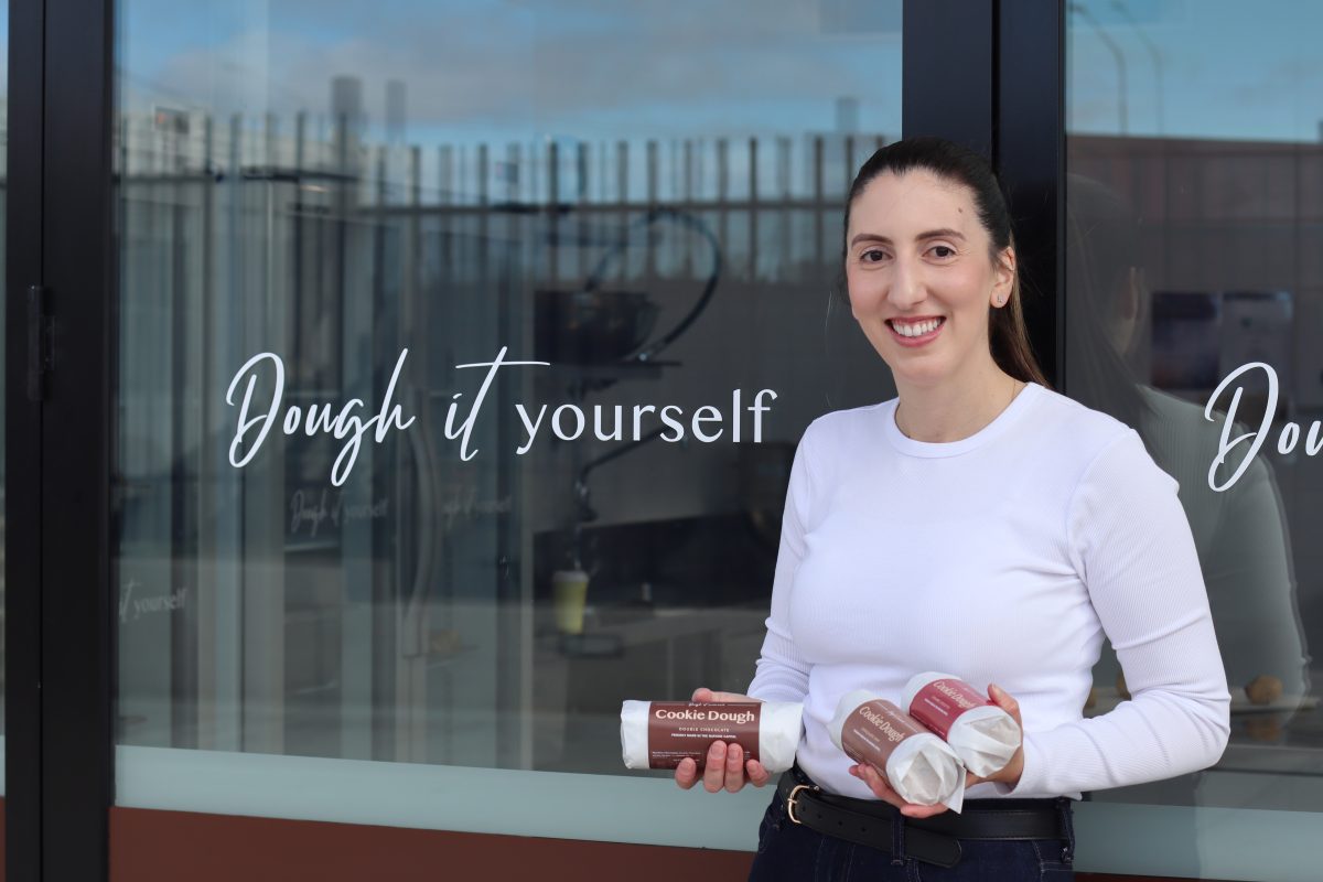 Woman holds cookie dough.