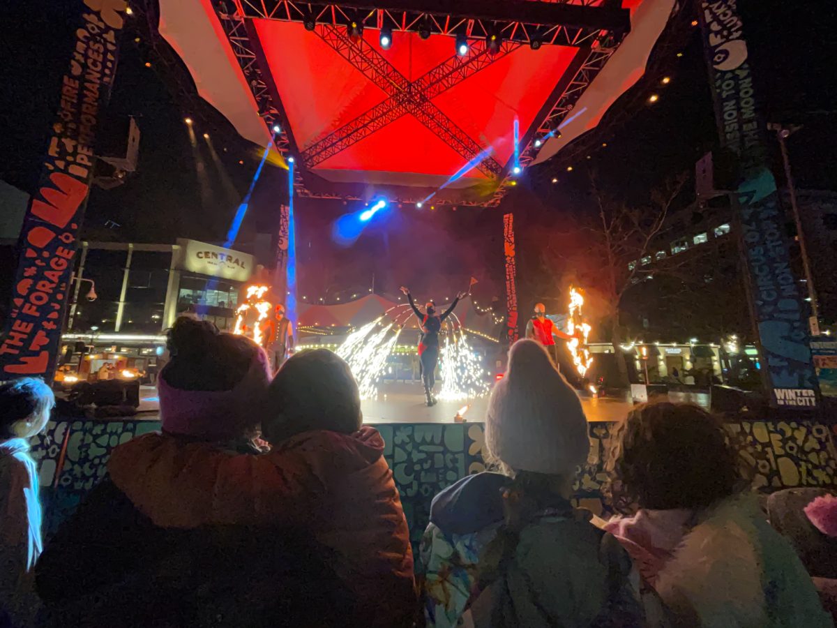 Families watch a fire performance,