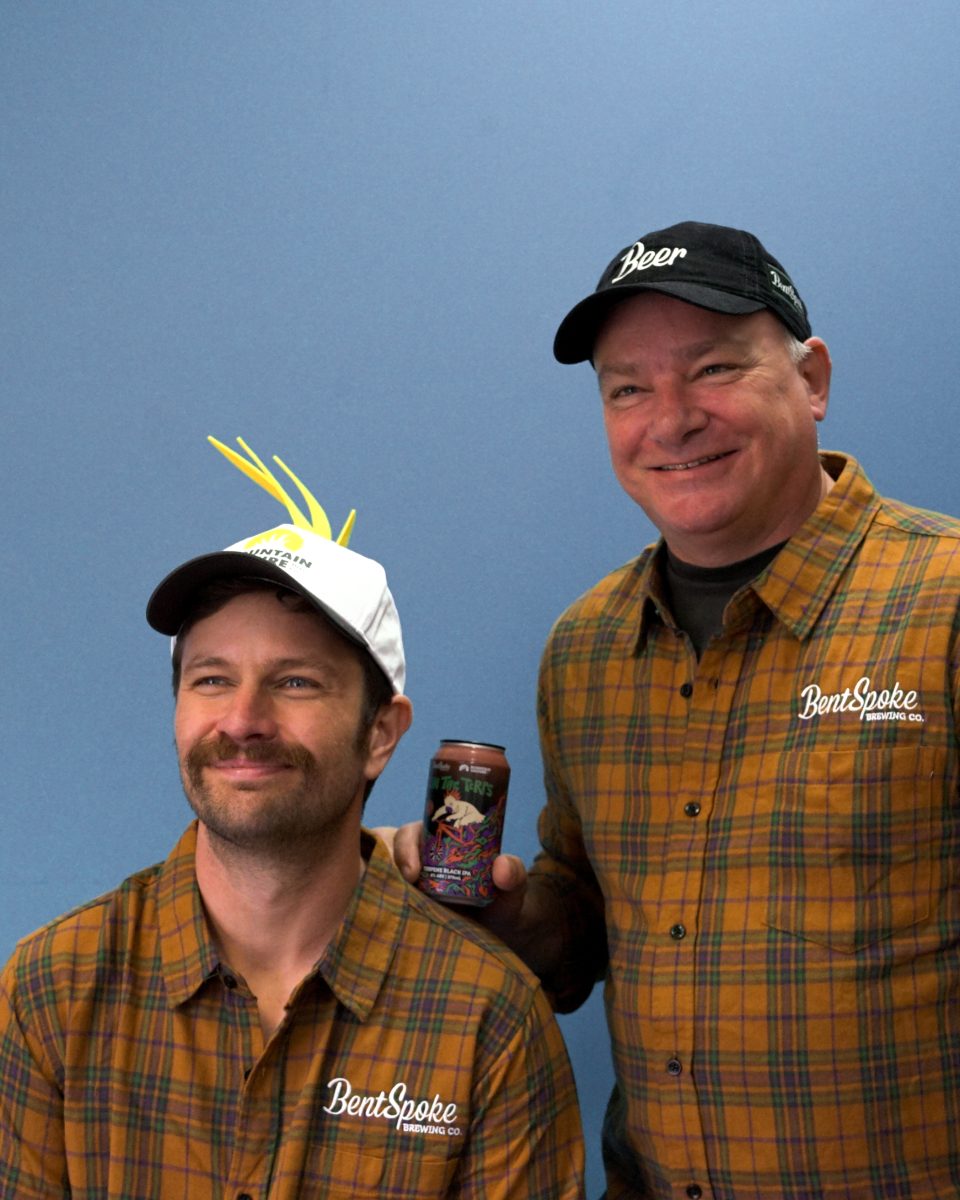 DJ McCready with Richard Watkins holding a can of beer.