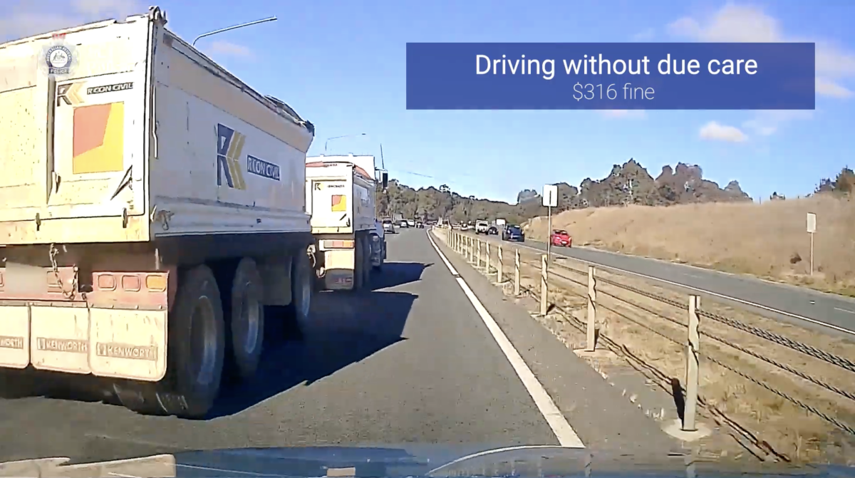 A truck driving over the middle lane