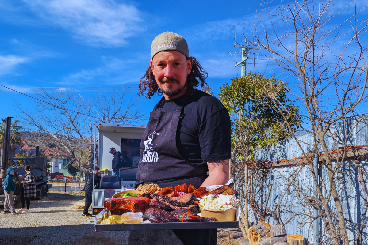 Man holding platter of American BBQ.