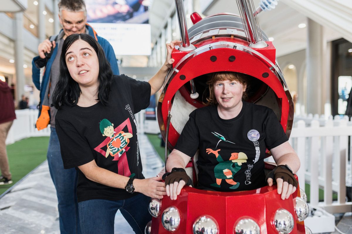 a person standing in a red dalek