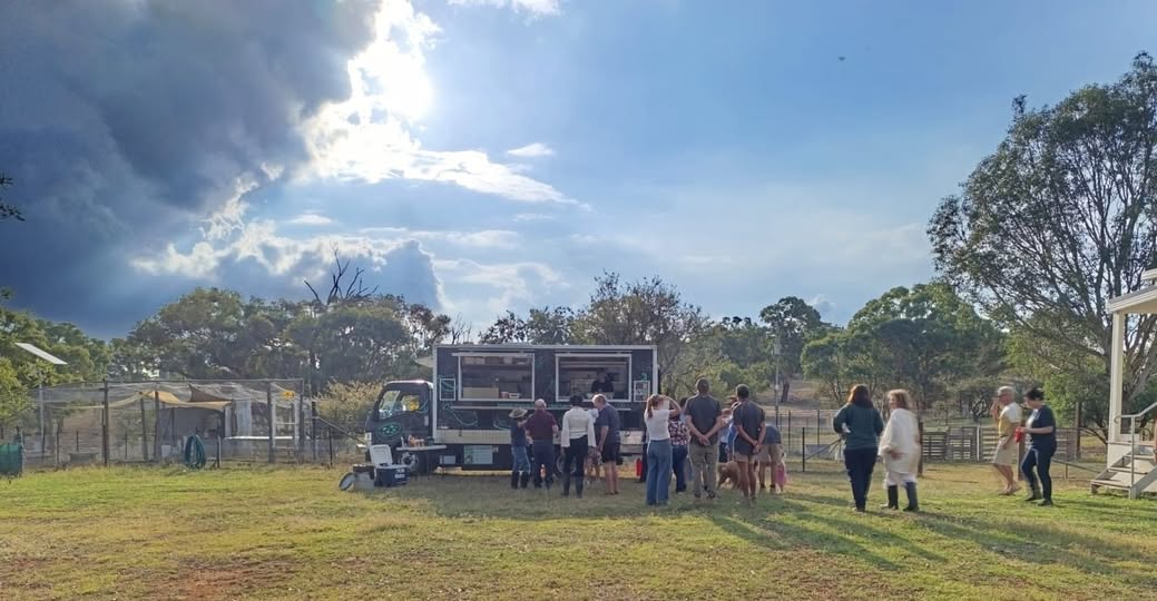 A food truck with people gathered around.